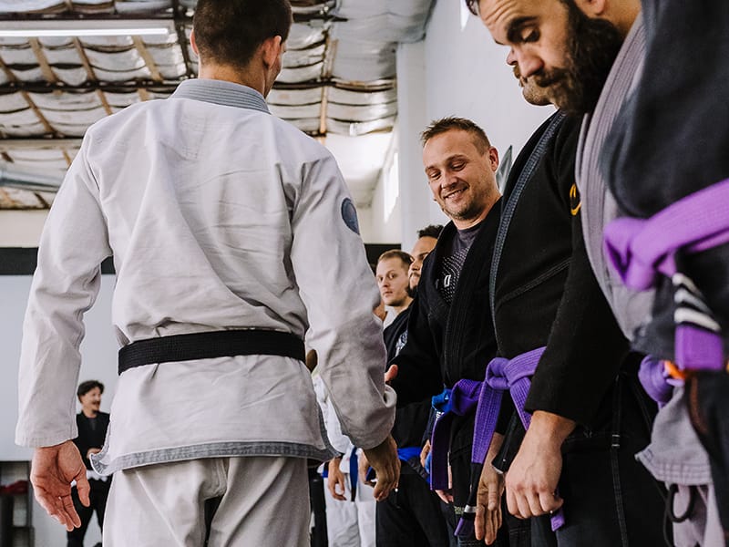 Black belt professor Matt Vernon shakes hands with his students before beginning adult BJJ class at Primate Jiu Jitsu in Tulsa OK